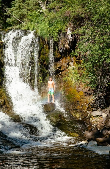 Shower under the falls at Siwash Lake Wilderness Resort